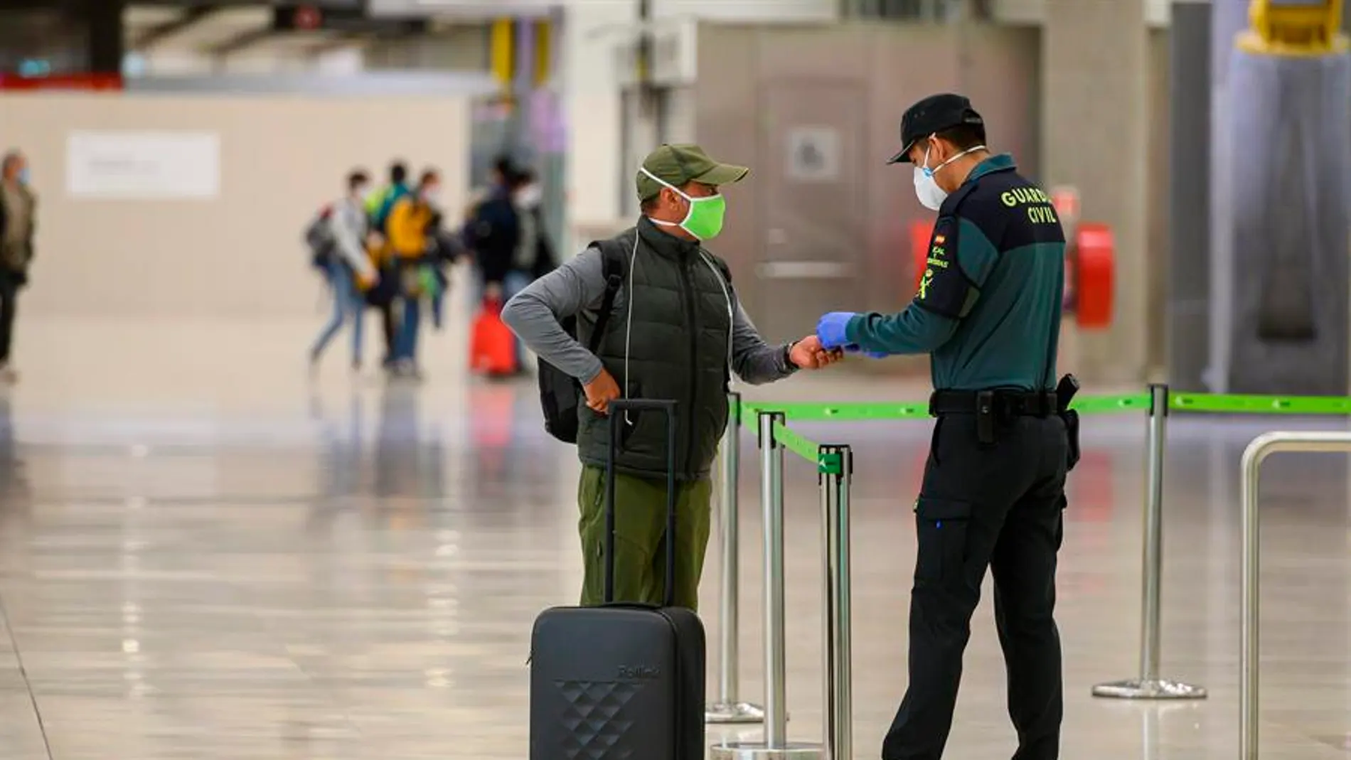 Un pasajero con mascarilla a su llegada al Aeropuerto de Barajas
