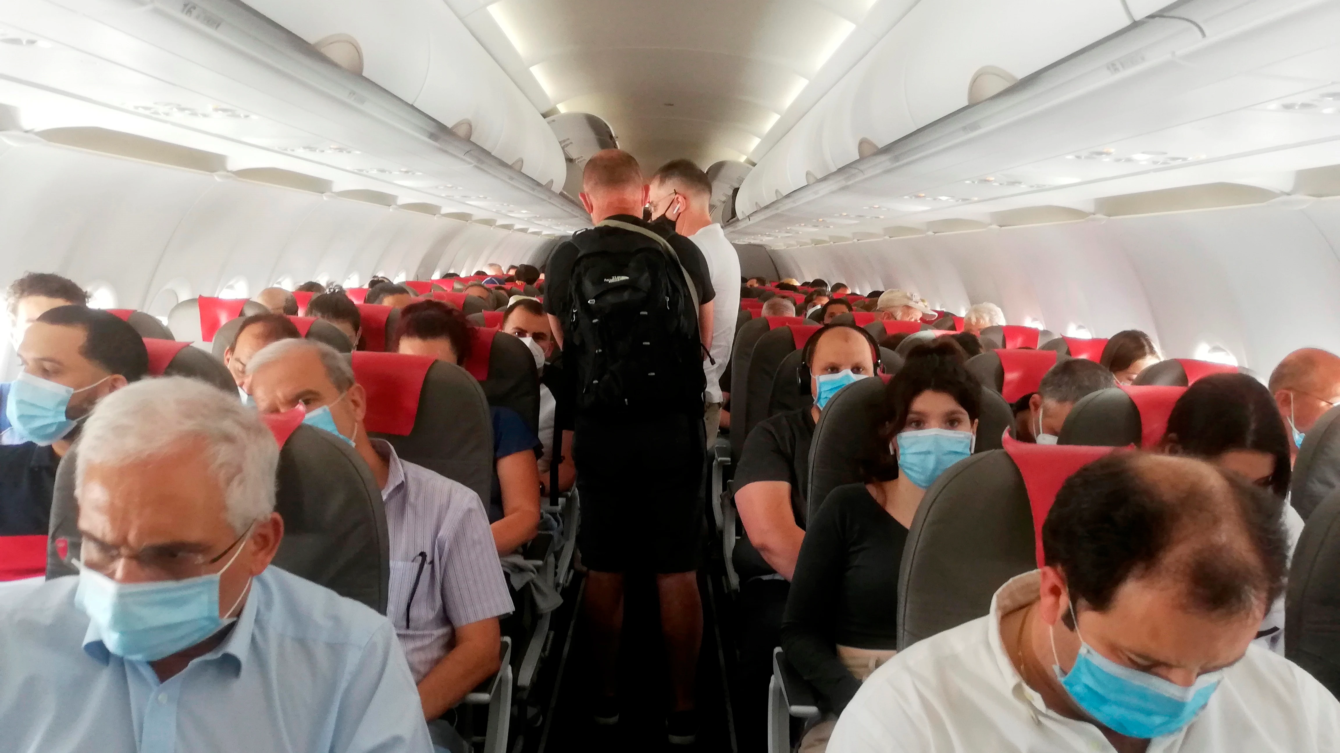 Pasajeros de un avión tras la crisis del coronavirus