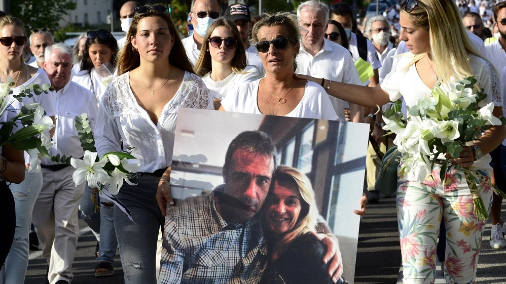 La mujer del fallecido sostiene un retrato junto a su marido durante una marcha en Bayona