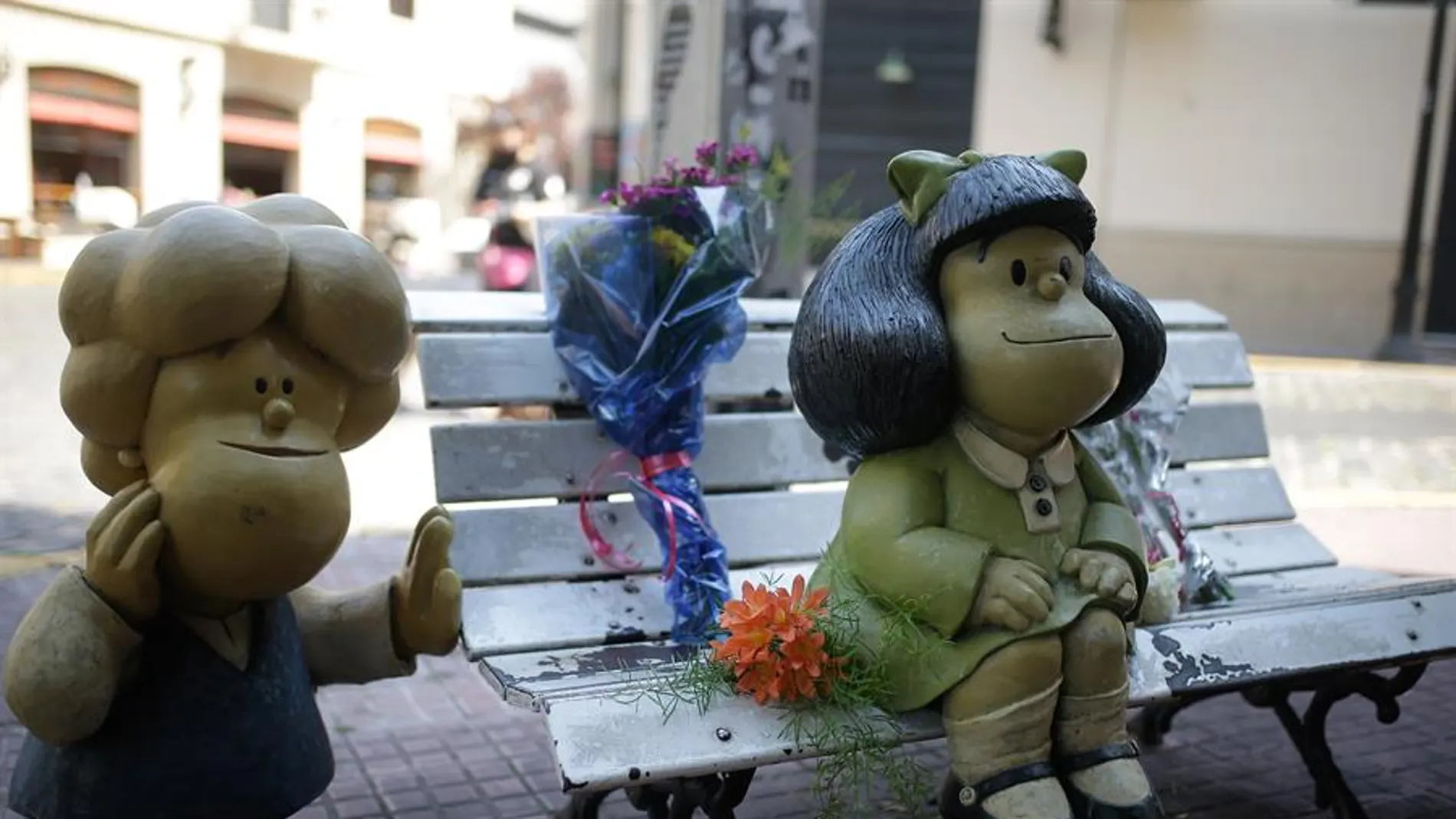 Flores junto a la escultura de Mafalda en Buenos Aires tras la muerte de Quino