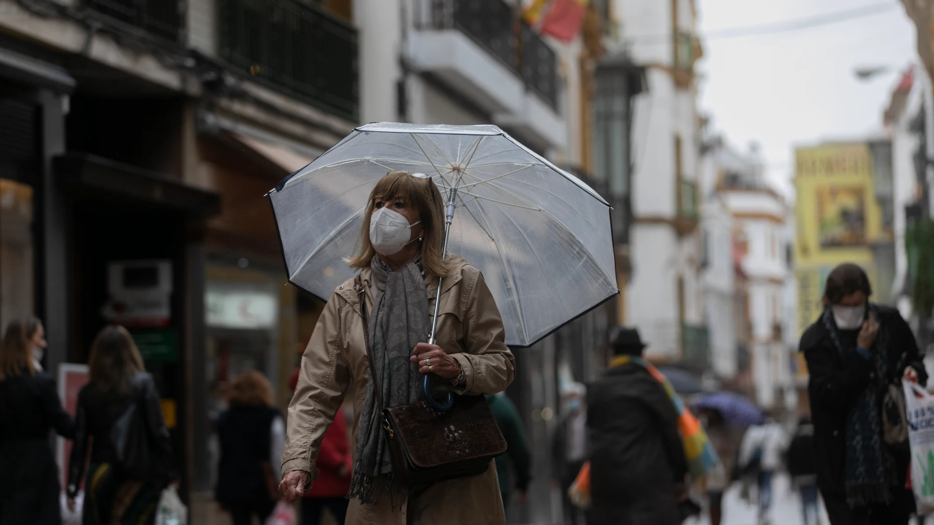 Una mujer bajo su paraguas en Sevilla