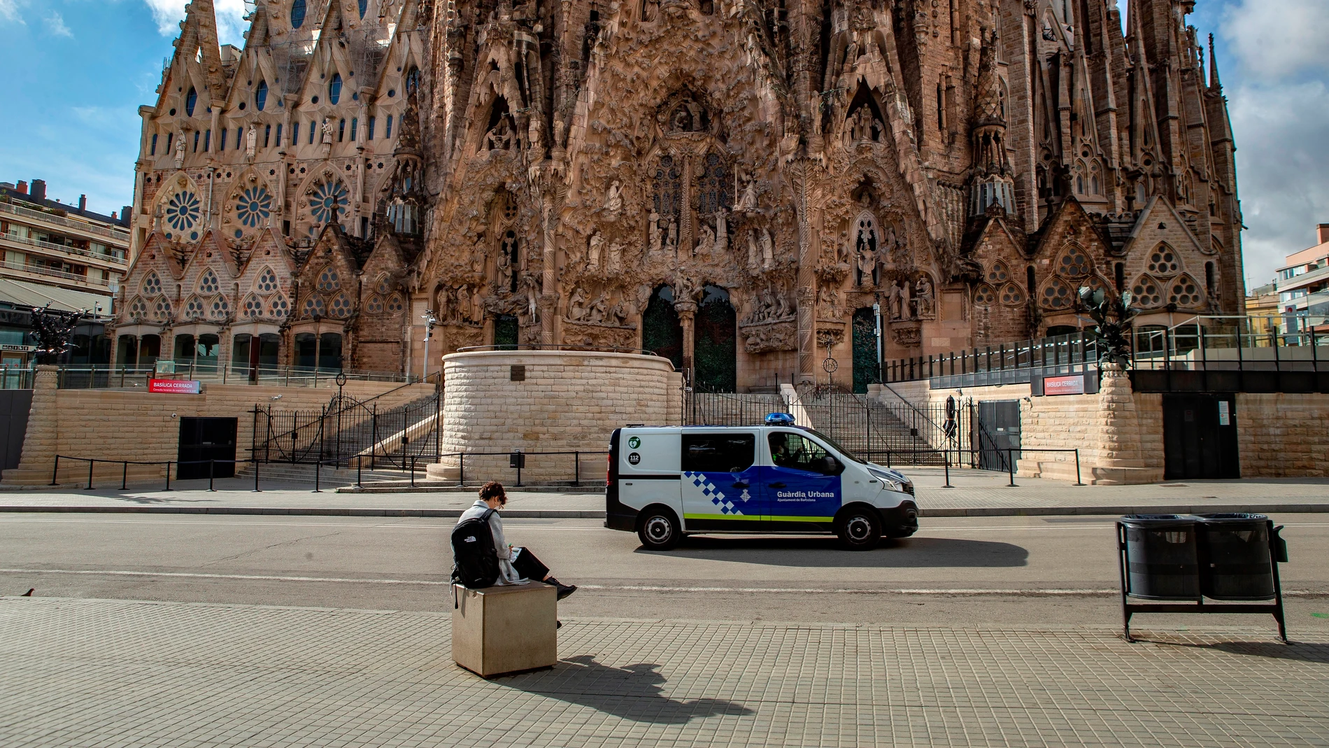 Una mujer sentada ante la Sagrada Familia de Barcelona