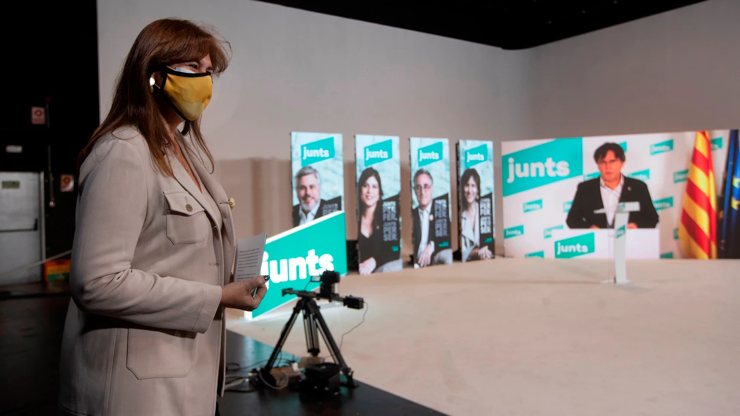 El acto de inicio de campaña de JuntsxCat, con Puigdemont vía Zoom y Laura Borràs en segundo plano. El acto de inicio de campaña de JuntsxCat, con Puigdemont vía Zoom y Laura Borràs en segundo plano.