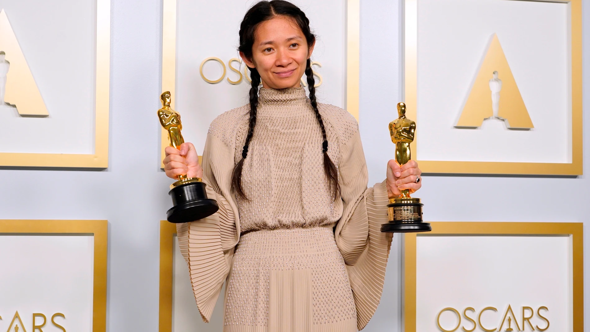 Chloé Zhao, directora de &#39;Nomadland&#39;, posando con dos premios Oscar