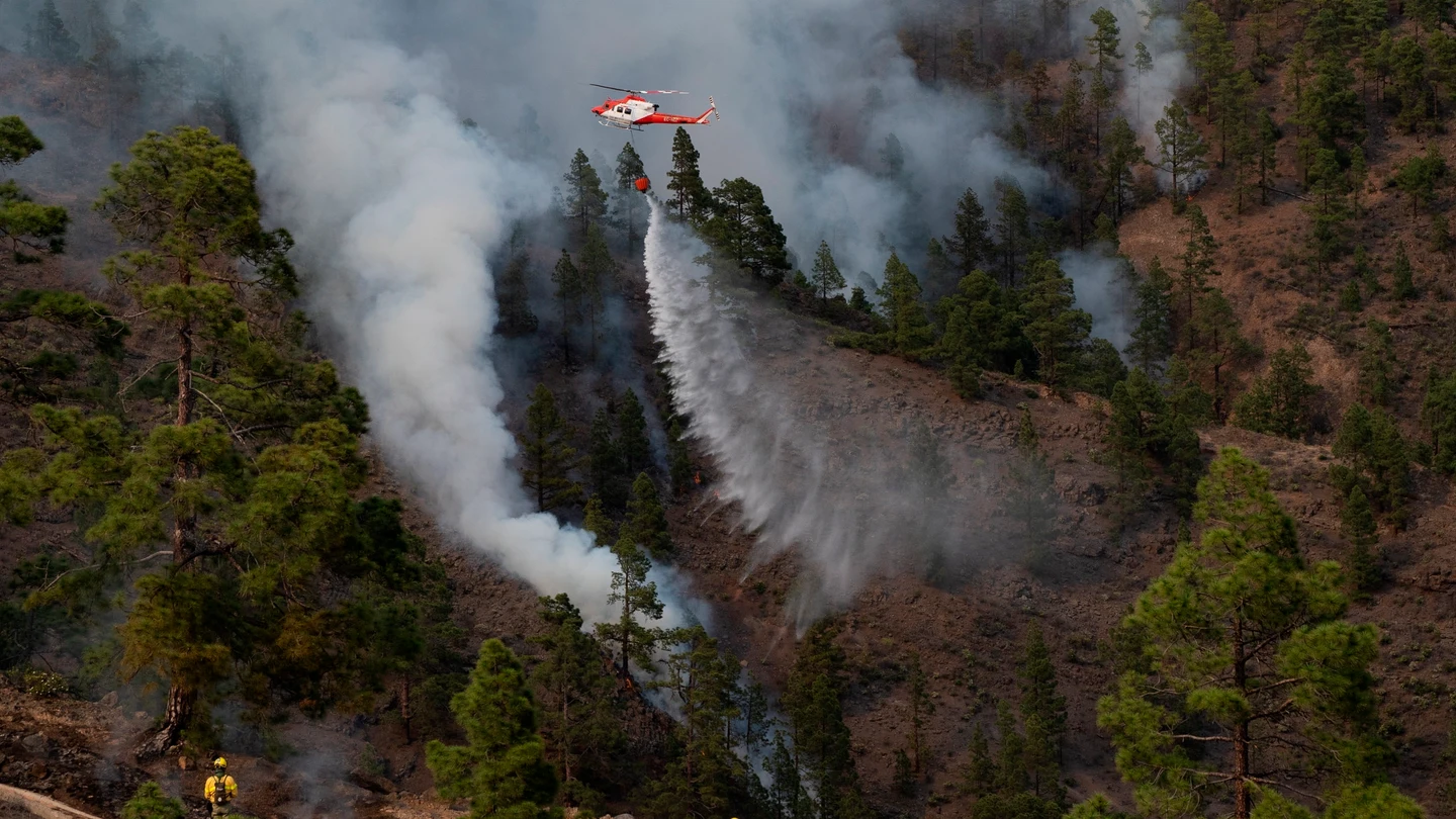 Un helicóptero del Gobierno de Canarias descarga agua sobre una de las zonas del incendio en el municipio de Arico Un helicóptero del Gobierno de Canarias descarga agua sobre una de las zonas del incendio en el municipio de Arico