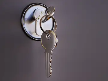 Imagen de archivo de varias llaves en la cerradura de una puerta.