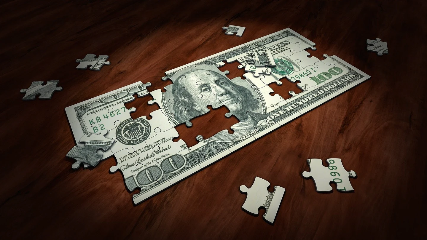 Puzzle con un billete de 100 dólares Puzzle con un billete de 100 dólares