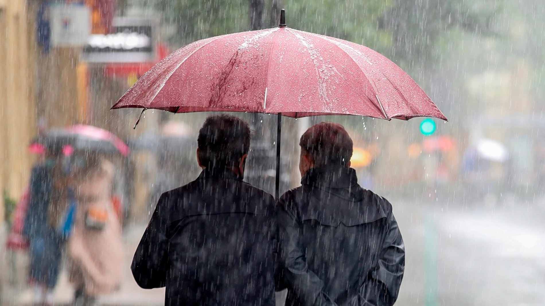 Imagen de dos personas protegiéndose de la lluvia con un paraguas