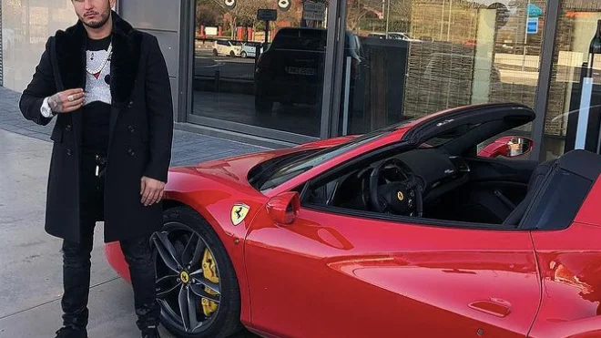 El cantante Omar Montes junto a un Ferrari.