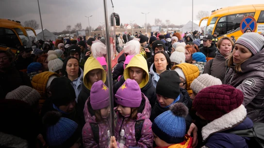 Personas que huyen de Ucrania hacen cola para abordar un autobús en el cruce fronterizo en Medyka, Polonia Personas que huyen de Ucrania hacen cola para abordar un autobús en el cruce fronterizo en Medyka, Polonia