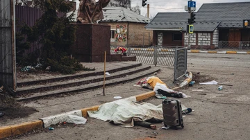 Bodies of people killed by Russian shelling lie covered in the street in the city of Irpin, Ukraine.