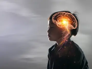 Niño con los ojos cerrados y un gráfico de su cerebro Niño con los ojos cerrados y un gráfico de su cerebro