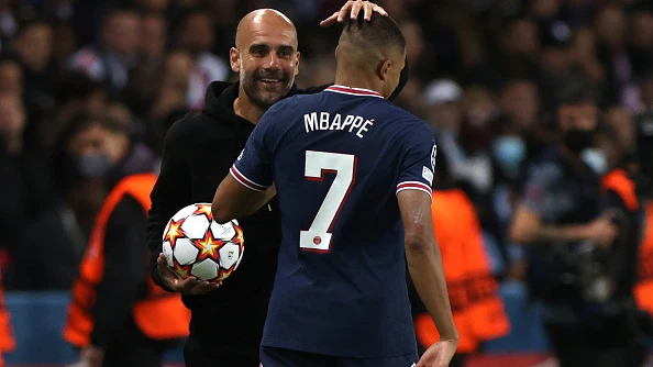 Pep Guardiola y Kylian Mbappé