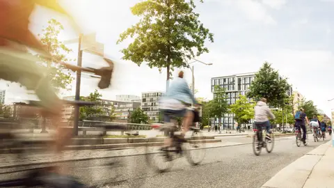 Gente en bici por una ciudad Gente en bici por una ciudad