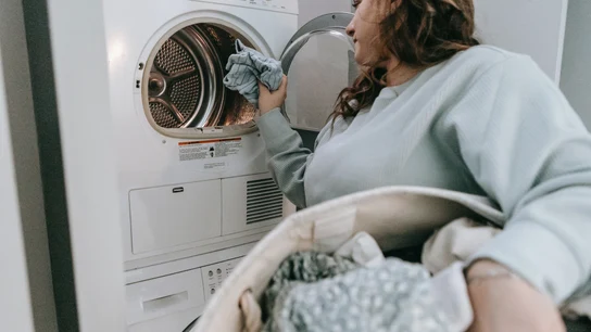 Una mujer poniendo una lavadora Una mujer poniendo una lavadora