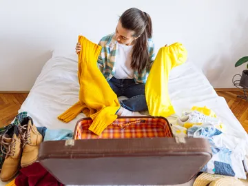Chica haciendo la maleta Chica haciendo la maleta