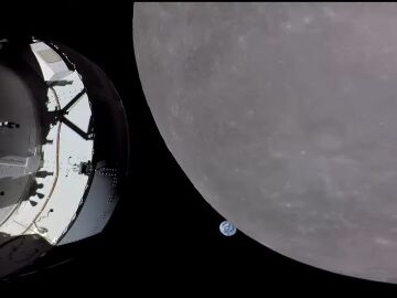 Aproximación de la nave Orion a la Luna, con la Tierra al fondo