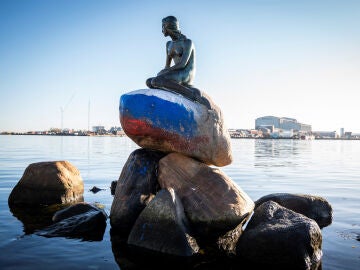 The Little Mermaid of Copenhagen dawns painted in the colors of the Russian flag