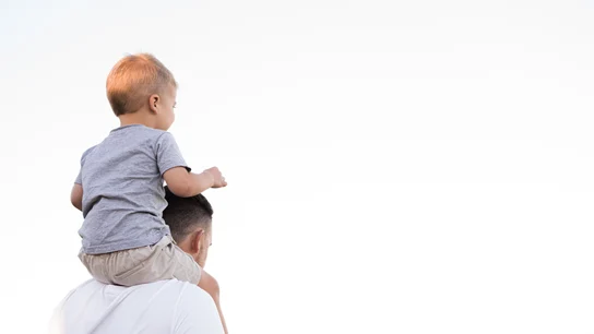 Un padre cargando a su hijo sobre los hombros Un padre cargando a su hijo sobre los hombros