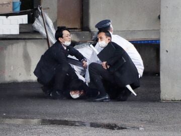 Japan’s prime minister evacuated by an explosion during an act