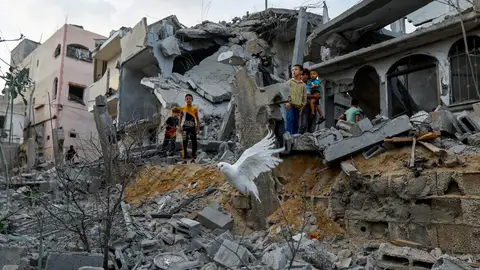 Niños sobre los escombros tras el bombardeo de Israel en Gaza