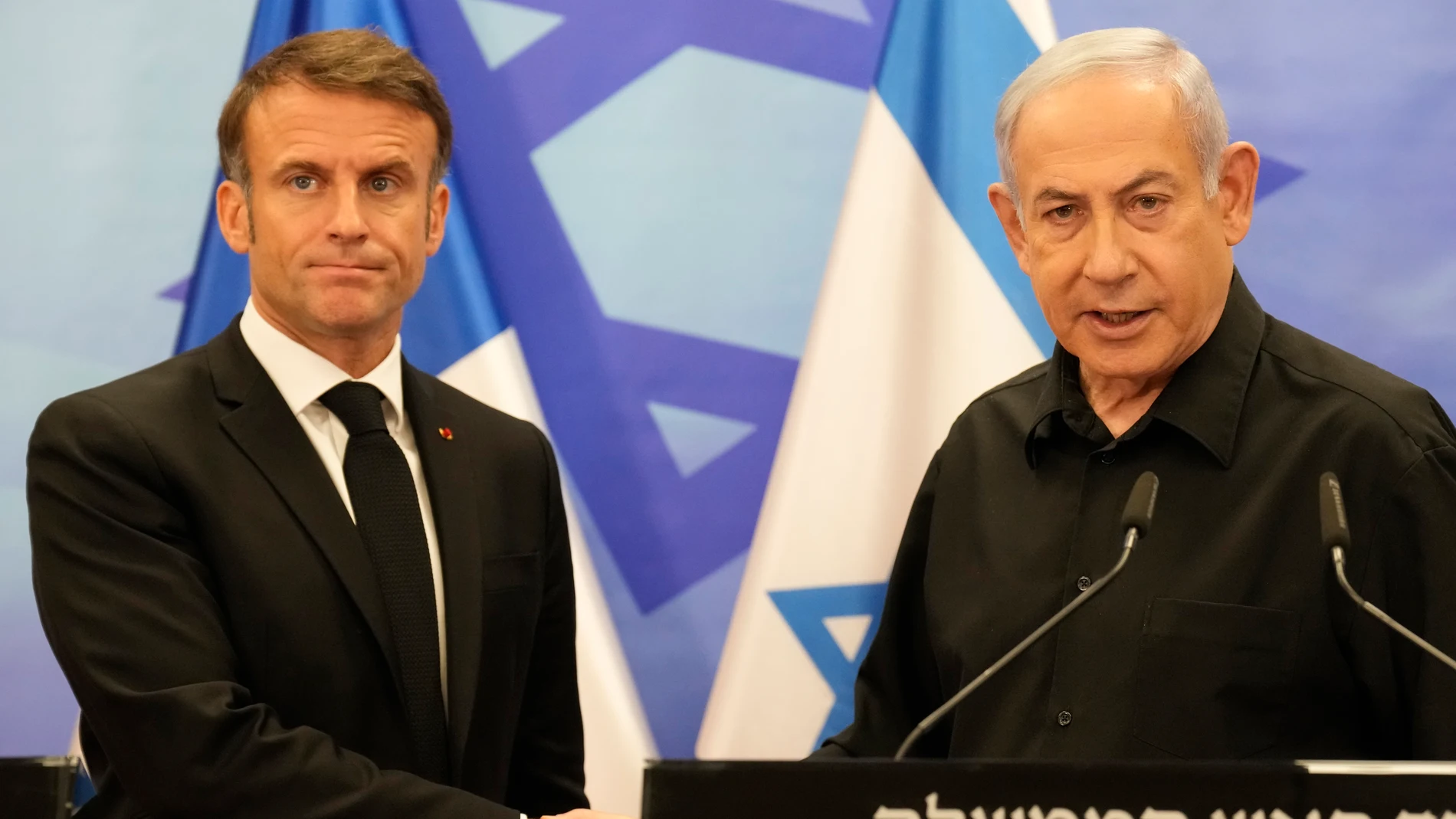El presidente francés, Emmanuel Macron, y el primer ministro israelí, Benjamín Netanyahu, se saludan tras su reunión en Tel Aviv