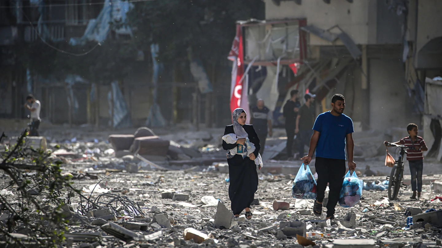Una familia palestina se abre paso entre los escombros de los edificios alcanzados en un bombardeo israelí sobre el barrio de Tel al-Hawa, en Ciudad de Gaza, el 30 de octubre. Una familia palestina se abre paso entre los escombros de los edificios alcanzados en un bombardeo israelí sobre el barrio de Tel al-Hawa, en Ciudad de Gaza, el 30 de octubre.