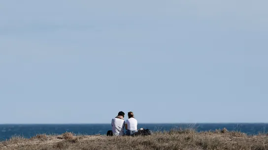Dos personas disfrutan de las agradables temperaturas registradas en la playa de Saler de Valencia Dos personas disfrutan de las agradables temperaturas registradas en la playa de Saler de Valencia