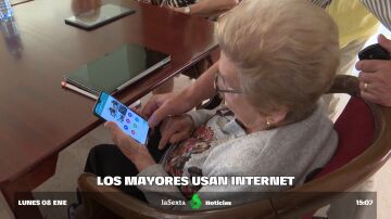Una mujer mayor usando su móvil