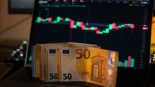 Varios billetes de 50 euros frente a un gráfico Varios billetes de 50 euros frente a un gráfico