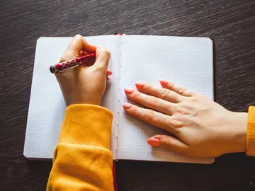mujer escribiendo con la mano izquierda mujer escribiendo con la mano izquierda