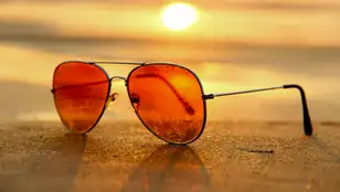 Unas gafas de sol sobre la arena de una playa en verano