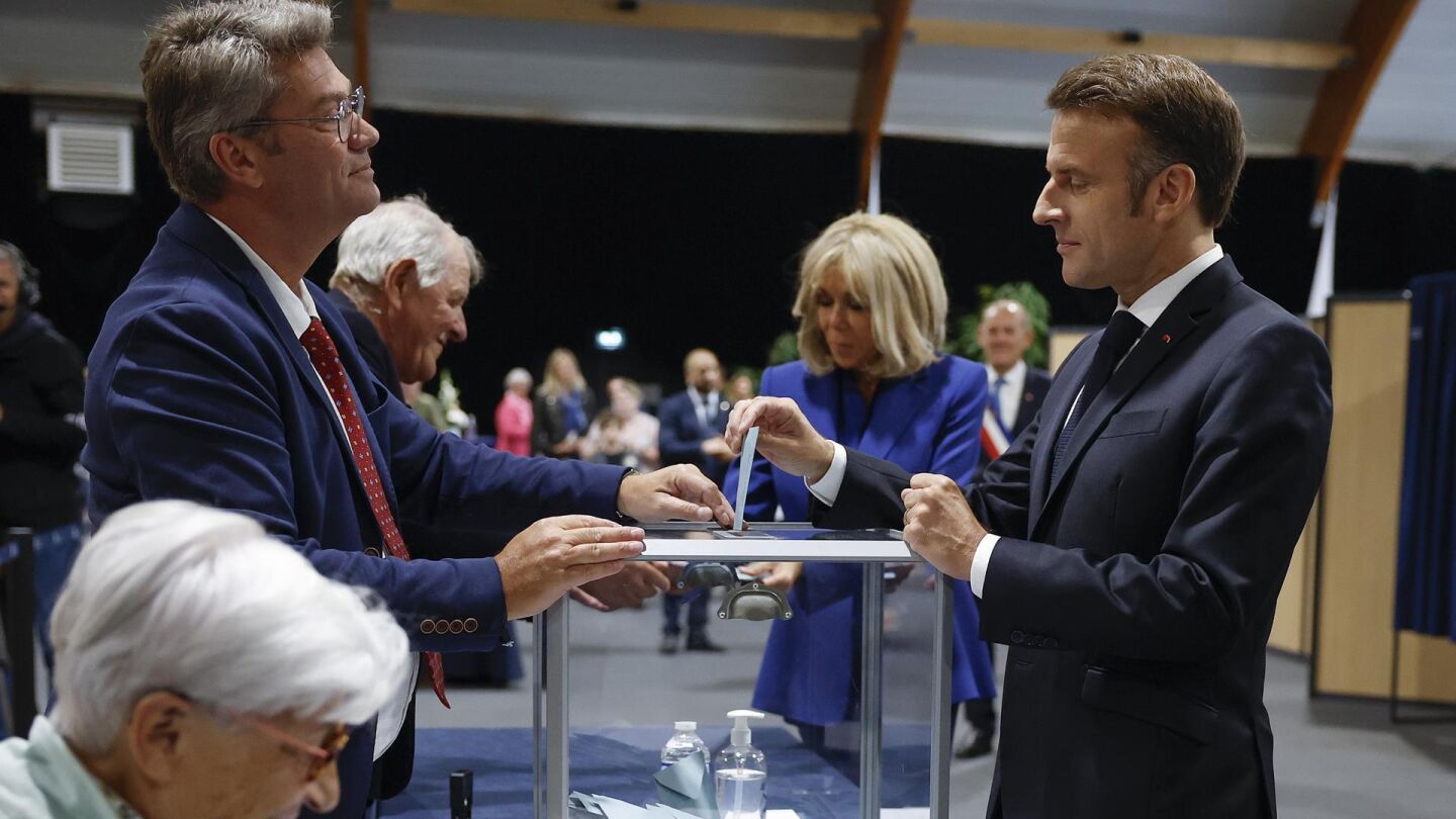 El presidente francés Emmanuel Macron vota junto a su esposa, Brigitte Macron
