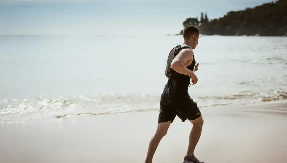 Un hombre practicando deporte en la playa Un hombre practicando deporte en la playa