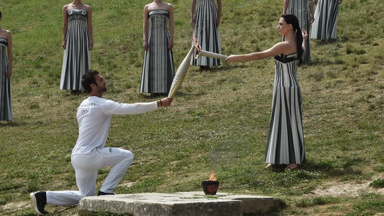 Stephanos Ntouskos, primer portador griego de la antorcha, recibe la llama de manos de la actriz griega Mary Mina, que interpreta el papel de la Gran Sacerdotisa, durante la ceremonia de encendido de la llama de los Juegos Olímpicos de Verano de París 2024. Stephanos Ntouskos, primer portador griego de la antorcha, recibe la llama de manos de la actriz griega Mary Mina, que interpreta el papel de la Gran Sacerdotisa, durante la ceremonia de encendido de la llama de los Juegos Olímpicos de Verano de París 2024.