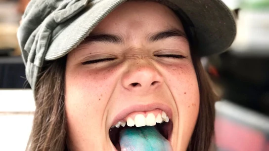 NIña con la lengua pintada de azul NIña con la lengua pintada de azul