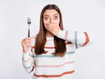 Mujer sorprendida al comer Mujer sorprendida al comer