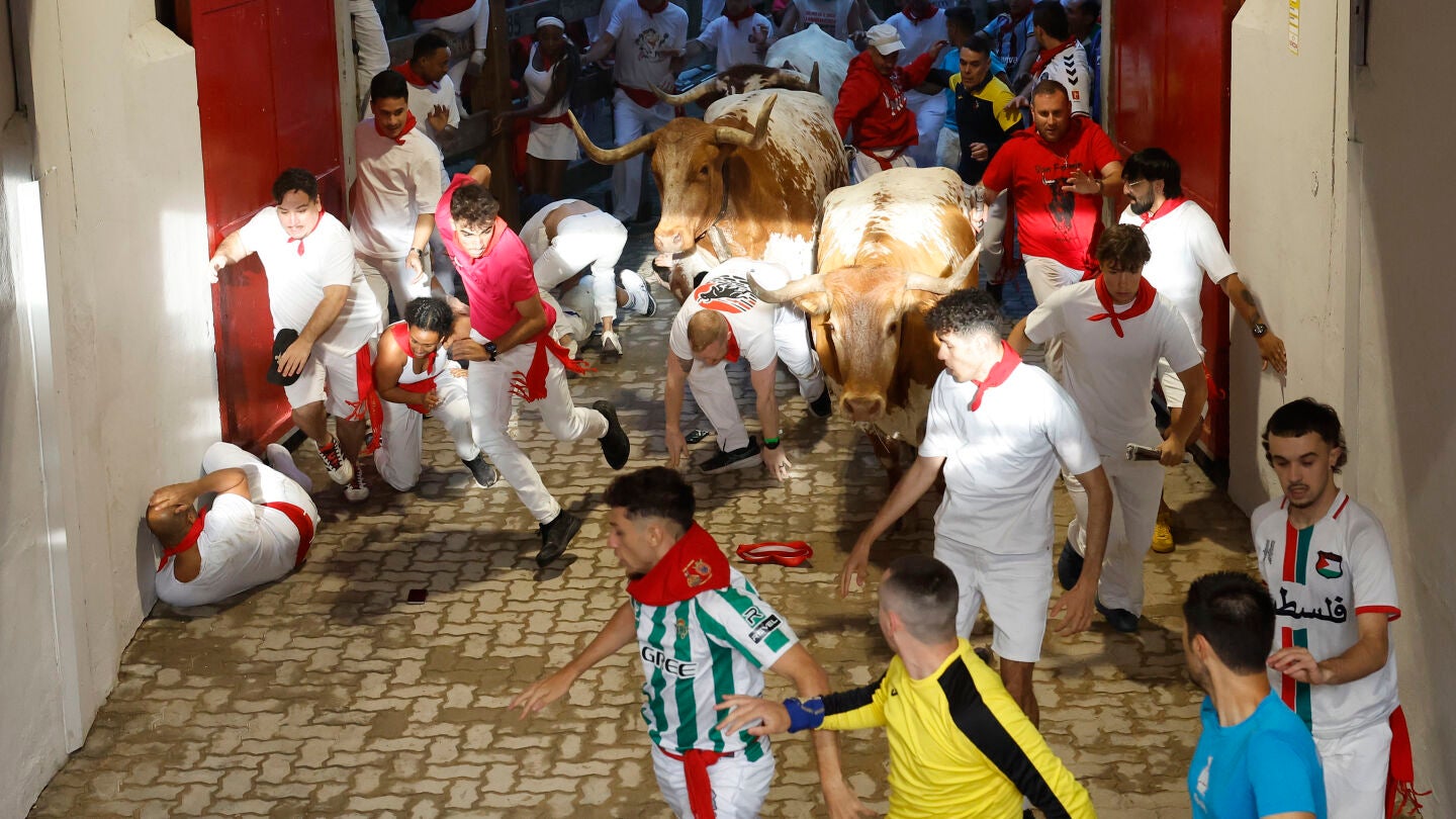Varios corredores son perseguidos por los toros de la ganadería Cebada Gago en el acceso a la Plaza de Toros durante el segundo encierro de los Sanfermines
