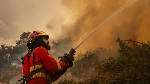 Un efectivo de la Unidad Militar de Emergencias (UME) en la localidad de A Espasa, durante el incendio forestal que permanece activo en Chandrexa de Queixa (Ourense), este martes. Un efectivo de la Unidad Militar de Emergencias (UME) en la localidad de A Espasa, durante el incendio forestal que permanece activo en Chandrexa de Queixa (Ourense), este martes.