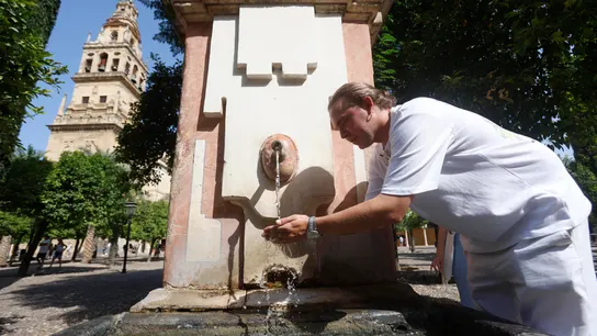 Imagen de archivo. Una persona se refresca en una fuente. Imagen de archivo. Una persona se refresca en una fuente.