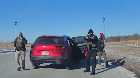 Agentes del Servicio de Inmigraci&oacute;n y Control de Aduanas de Estados Unidos (ICE) apuntando a una mujer que les estaba grabando.