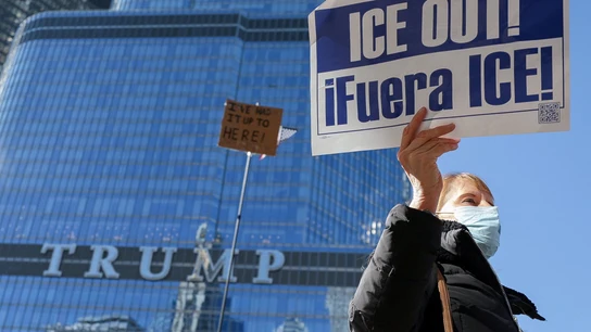 Una mujer sostiene una pancarta con un lema contra el ICE mientras manifestantes pasan frente a la Torre Trump Una mujer sostiene una pancarta con un lema contra el ICE mientras manifestantes pasan frente a la Torre Trump