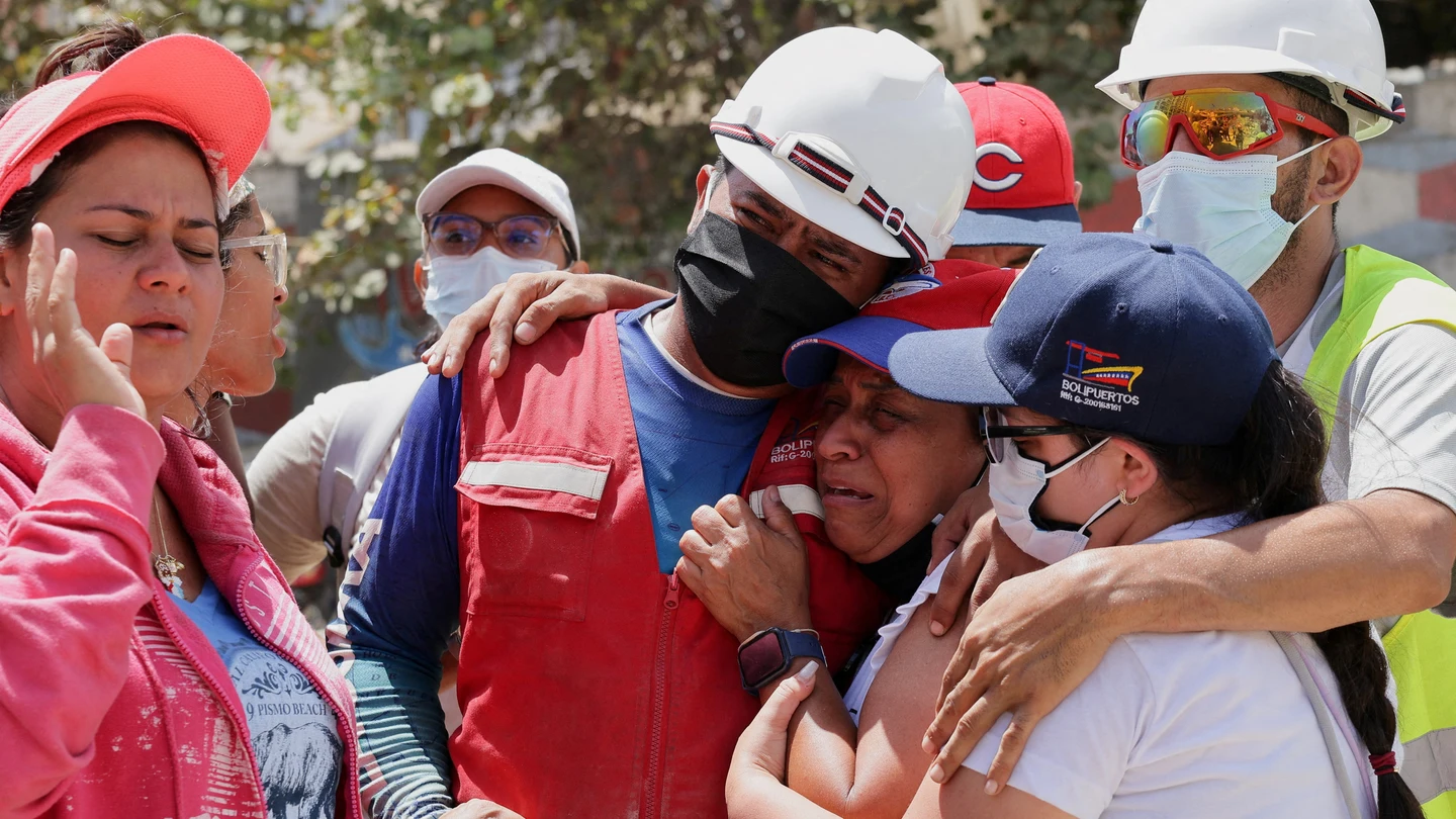 Personas reaccionan a las noticias transmitidas por un equipo de rescate tras los terremotos en La Guaira, Venezuela Personas reaccionan a las noticias transmitidas por un equipo de rescate tras los terremotos en La Guaira, Venezuela