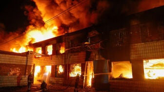 Bomberos trabajan en un complejo de una empresa privada da&ntilde;ado durante los ataques con misiles rusos, en el marco del ataque de Rusia contra Ucrania, en Kyiv