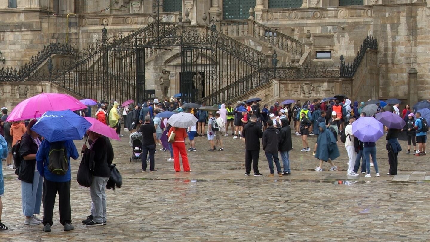 Los turistas se resguardan de la lluvia en Santiago de Compostela