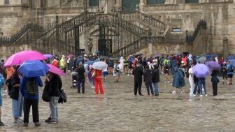 Los turistas se resguardan de la lluvia en Santiago de Compostela