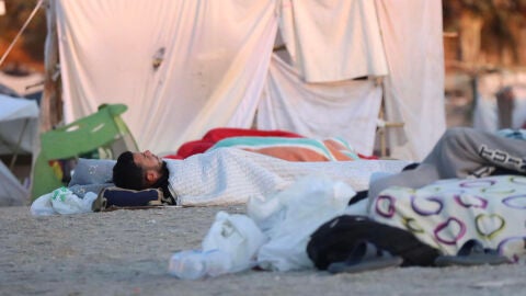 Migrantes duermen en la playa de El Trampol&iacute;n (Ceuta)