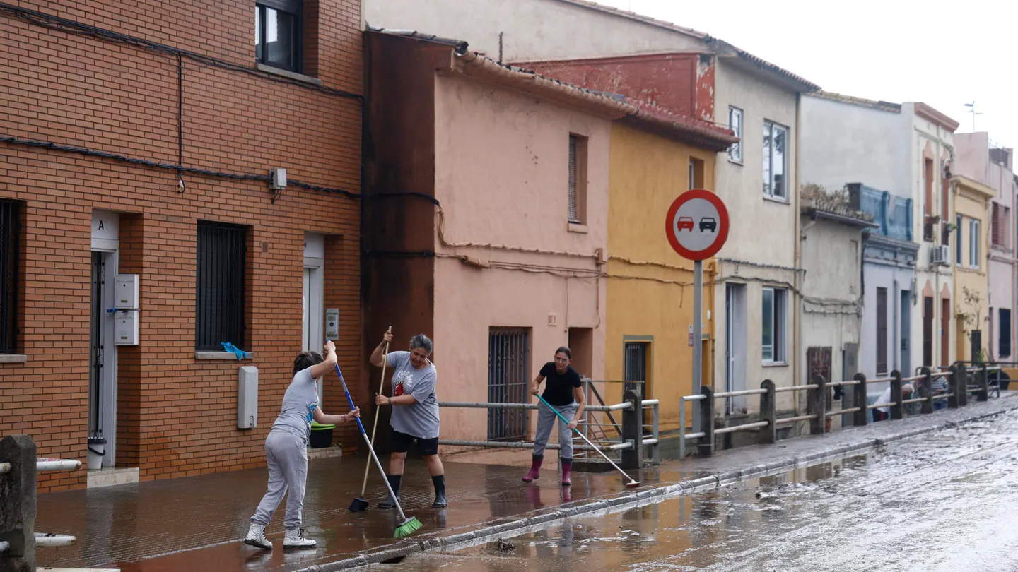 Varios vecinos, quitando el agua de las aceras Varios vecinos, quitando el agua de las aceras