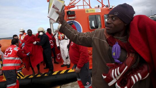 Uno de los inmigrantes muestra una Biblia al llegar ayer a tierra, en C&aacute;diz.