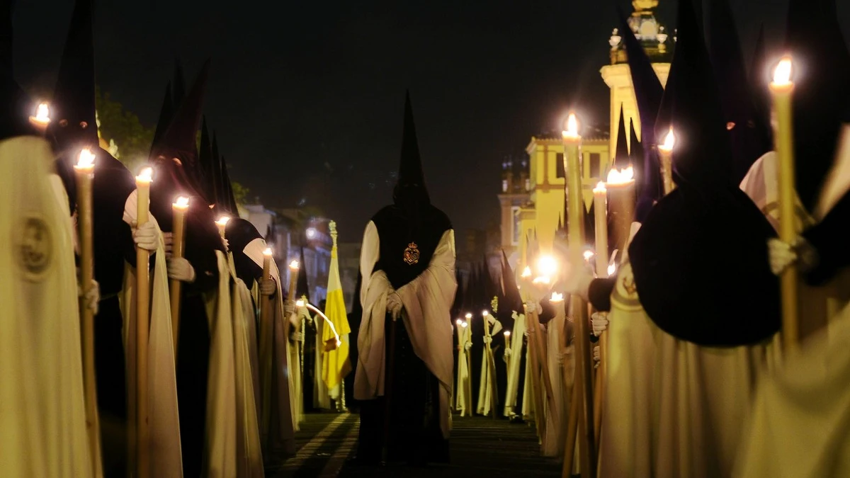 Un grupo de nazarenos en una procesión de la Semana Santa de Sevilla